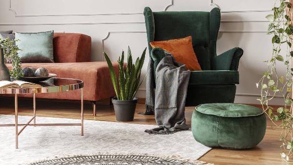 A corner of a living room with rugs on the floor. 