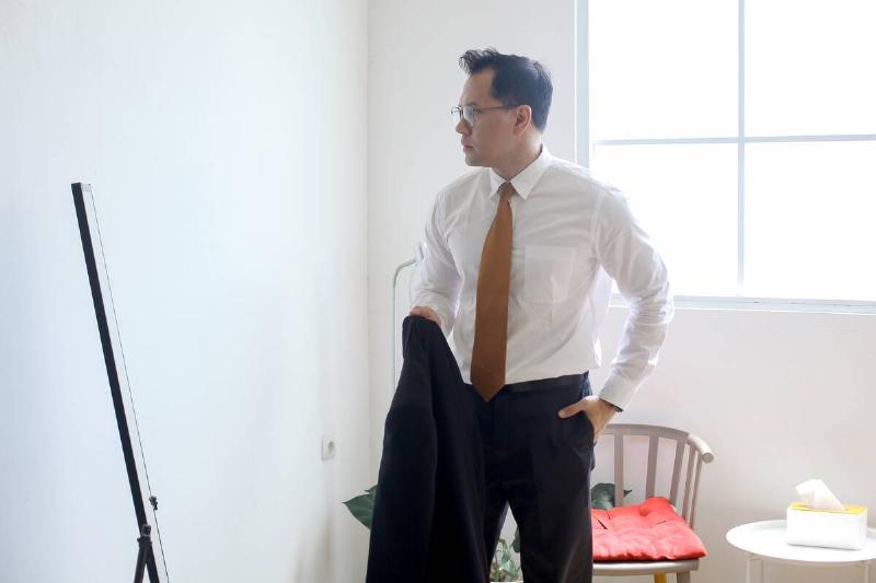 Man getting dressed before work.