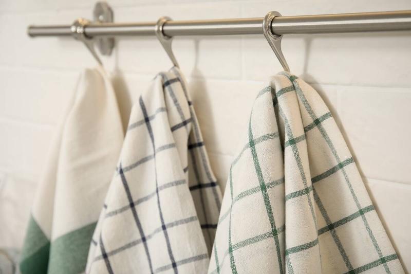 Different kitchen towels hanging on rack.