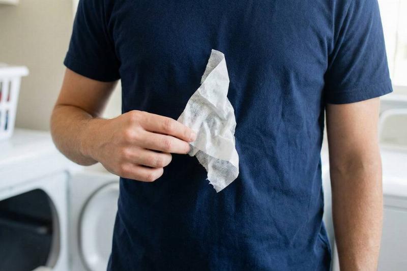 A dryer sheet stuck on a shirt.