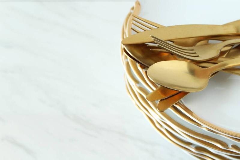 Gold plated plates and cutlery. 