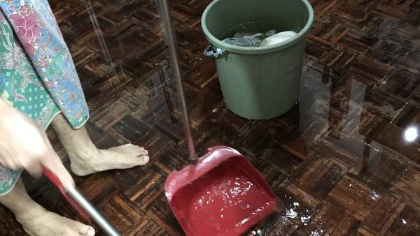 Lady cleaning floors with tons of water.