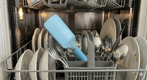 A hairbrush in a dishwasher. 