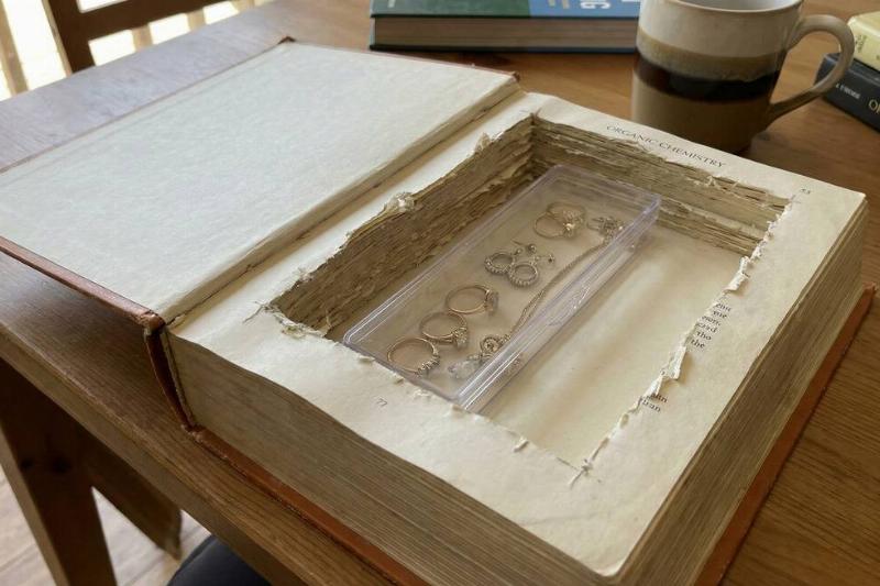 A hollowed out book with valuables stored inside.