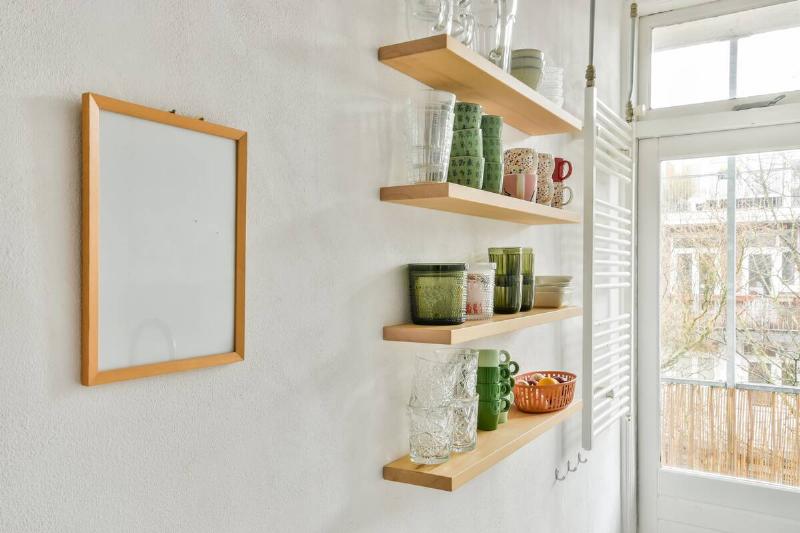 Kitchen dishes and cups on floating shelves. 