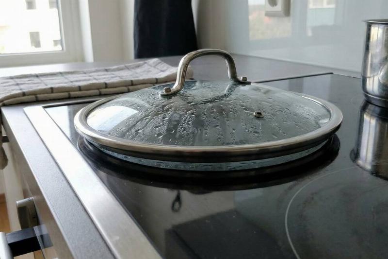A glass lid vacuum sealed on a glass top stove. 