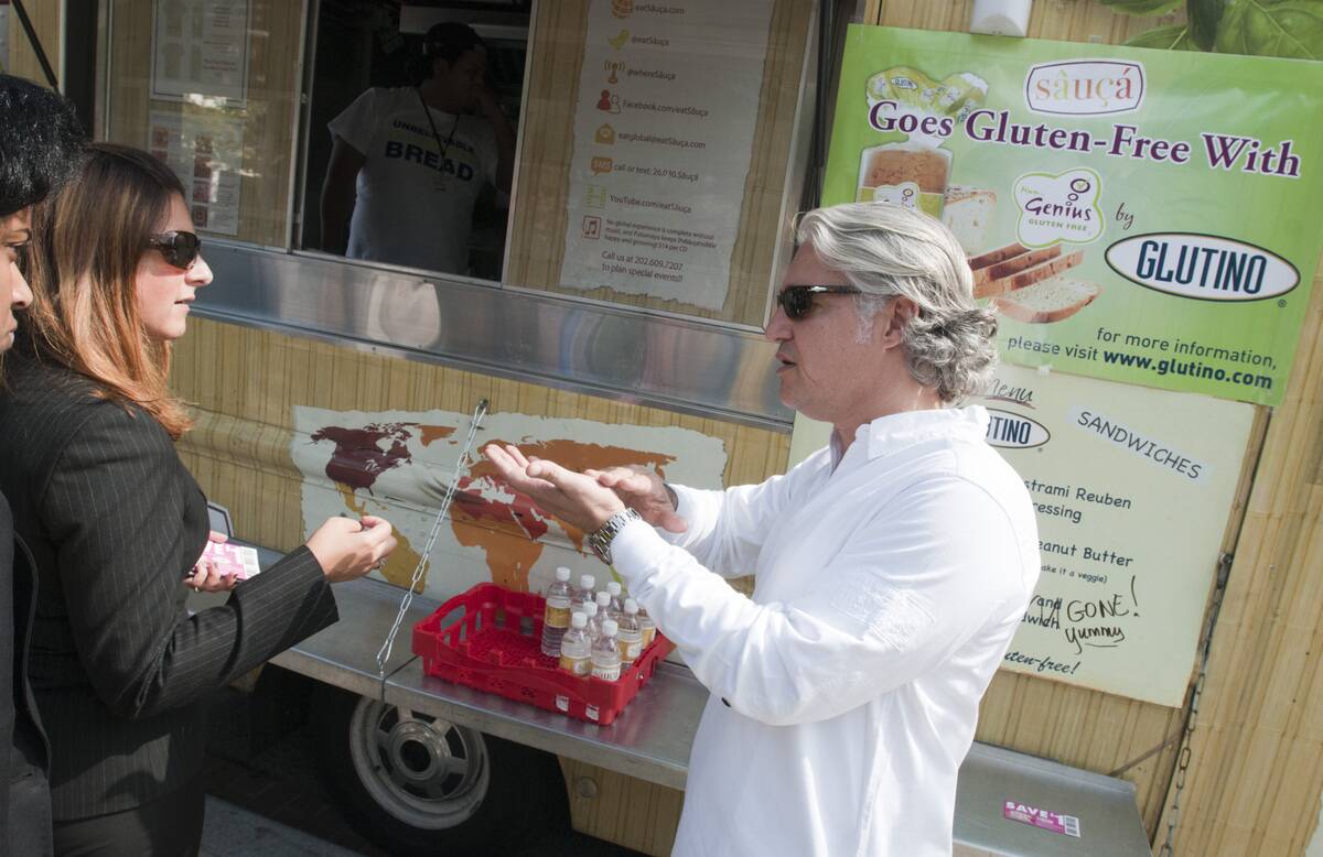 Farhad Assari standing in front of a food truck