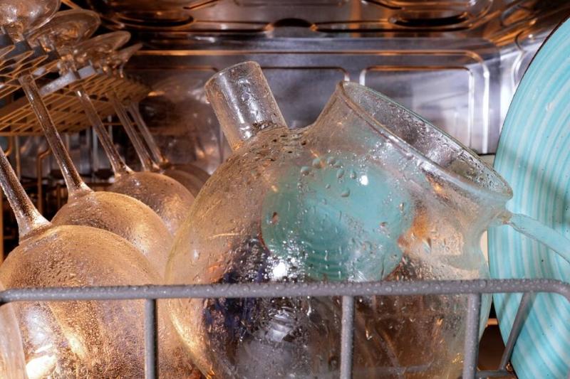 Open dishwasher with clean dishes.