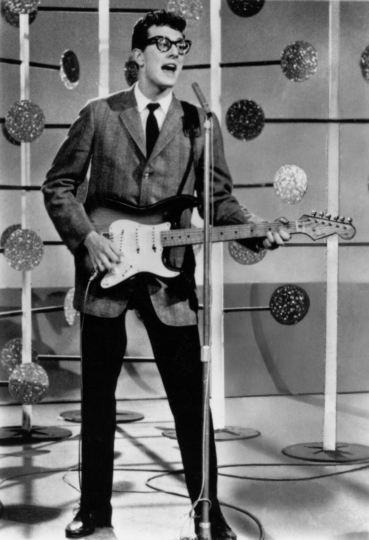 Buddy Holly performing on stage