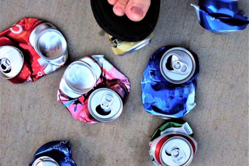 Foot crushing a can.