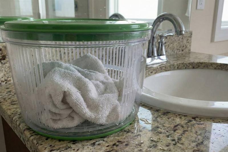 Salad spinner with a hand towel in it. 