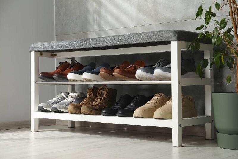 Bench in entryway that also holds shoes.