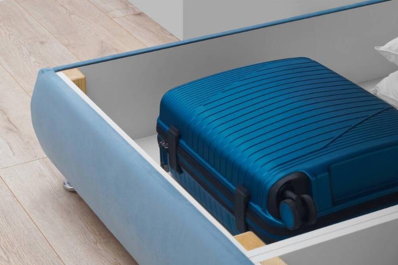 A storage drawer with a suitcase inside to go under a bed. 
