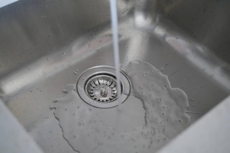 Water from faucet going down sink. 