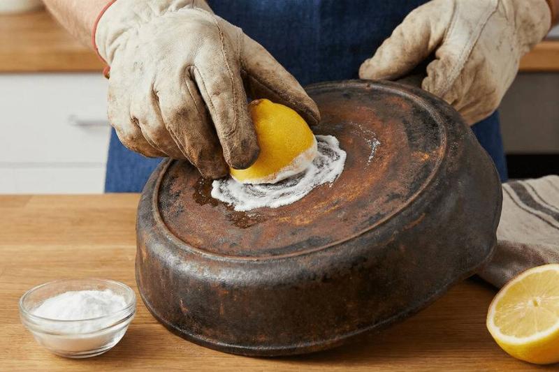 Scrubbing a pan with a lemon and baking soda. 