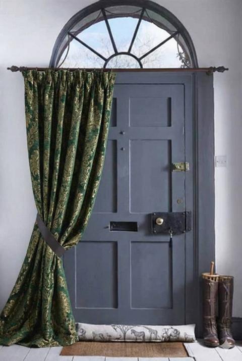 A heavy curtain hanging over a door. 
