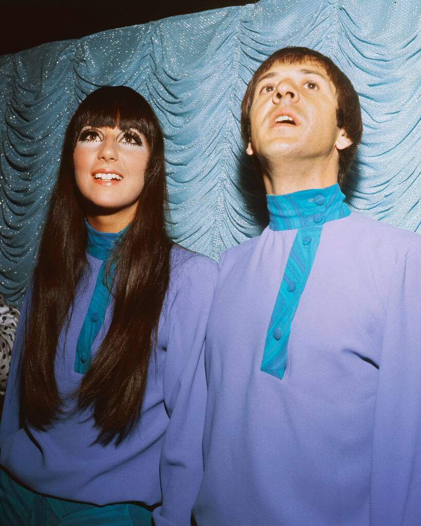Sonny Bono and Cher looking up