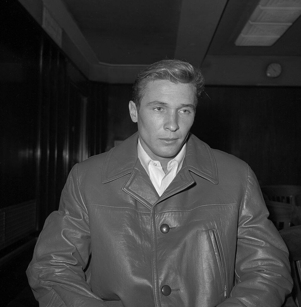 Joe Amsler walking in a leather jacket