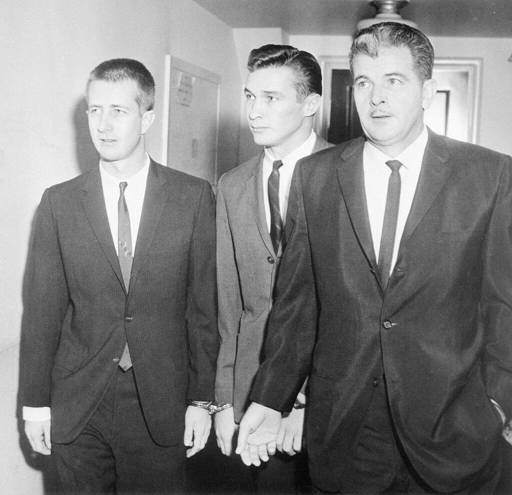Barry Keenan, Joe Amsler and John Irwin walking together in a hallway