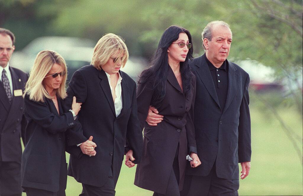 Cher walking with other mourners