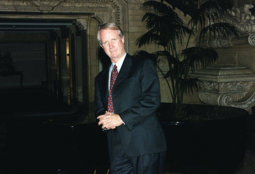 Barry Keenan standing in a suit, outside a building