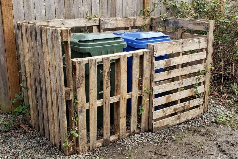 Pallets used to hide garbage bins.