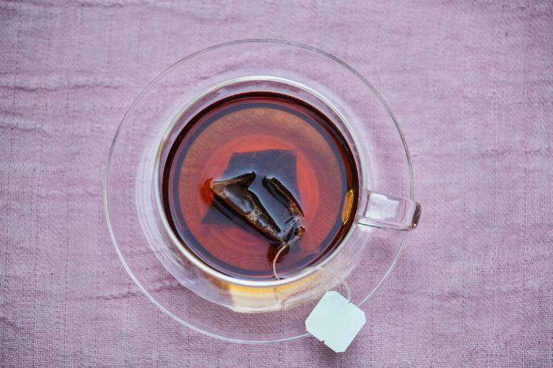 Black tea brewing in a clear mug.