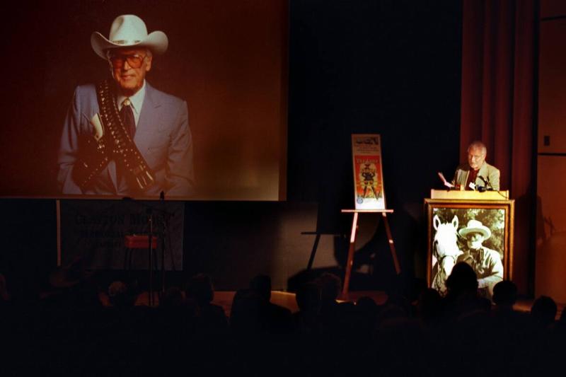 An image of Clayton Moore is projected onto a screen inside an auditorium at the Gene Autry Western