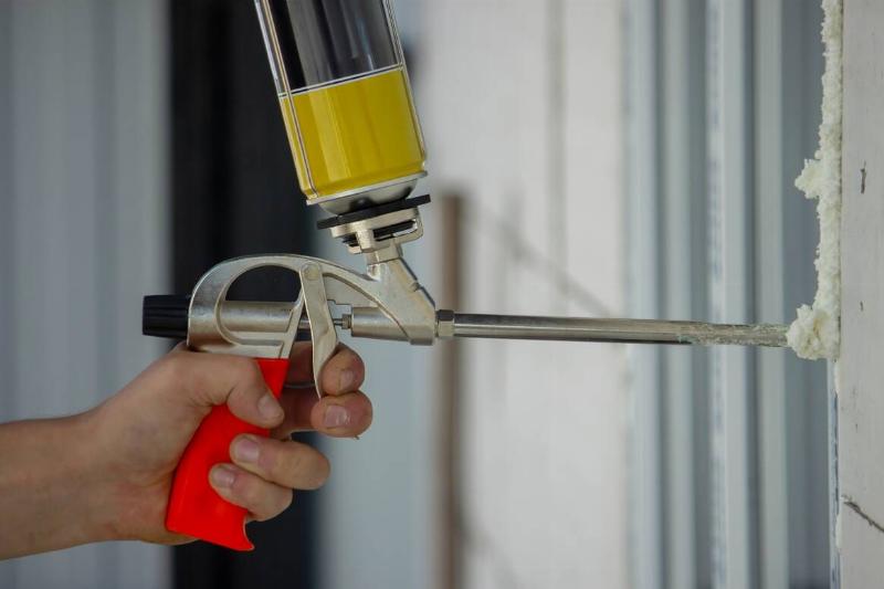 Applying expanding foam.