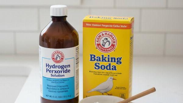 A bottle of hydrogen peroxide and a box of baking soda. 
