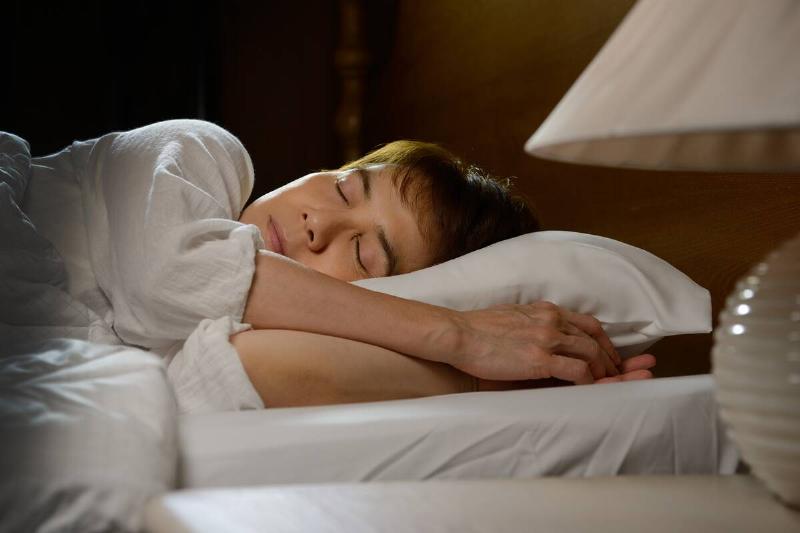 Woman sleeping soundly at night.