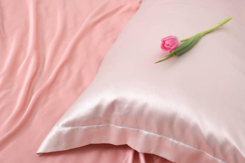 A silk pillowcase with a tulip on it. 