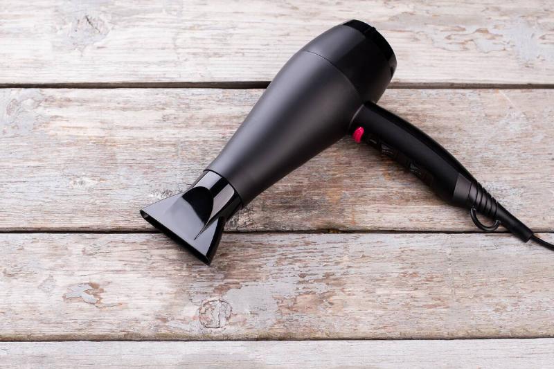 Hair dryer on a wooden background. 