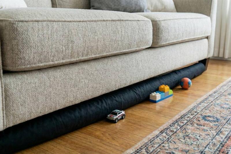 Pool noodle blocking toys from going under the couch. 