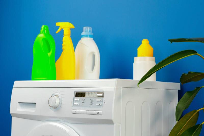 Chemicals on top of laundry machine. 