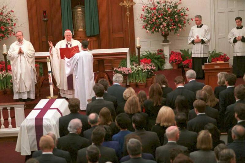 Cardinal Bernard Law reads during the funeral mass