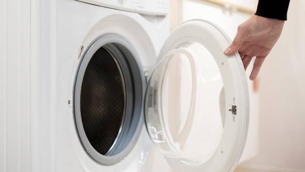 Hand opening washing machine door. 
