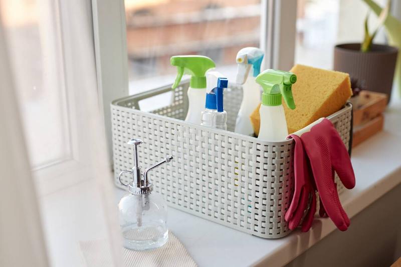 A basket holding different cleaning products.