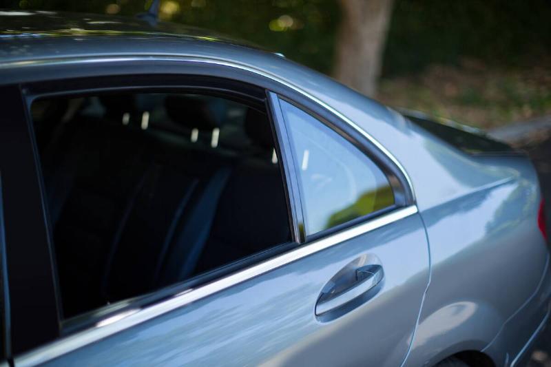 Gray car with windows rolled down. 