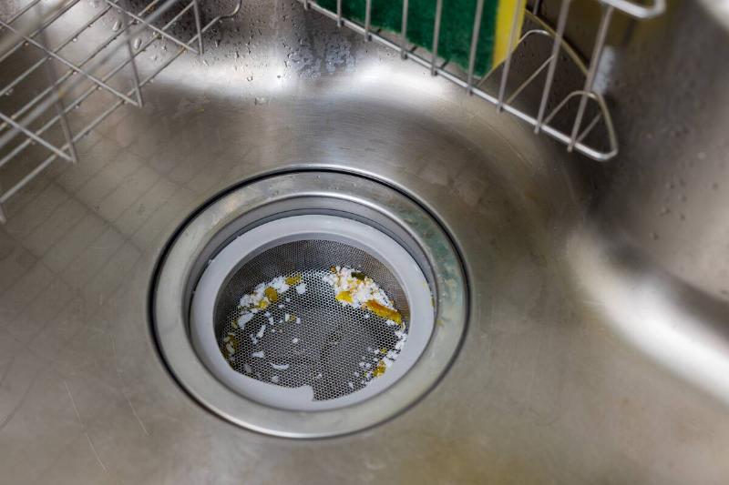 A dirty kitchen sink drain. 