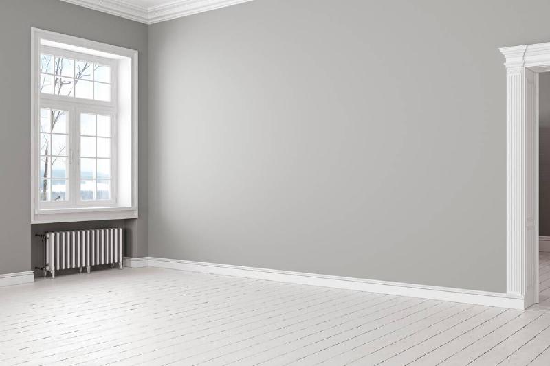 An empty room with gray paint on the walls.