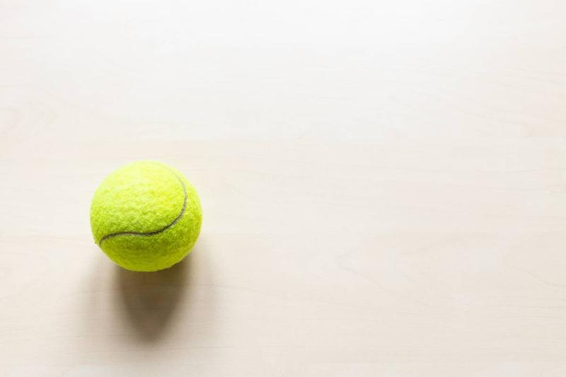 A tennis ball on a light background. 