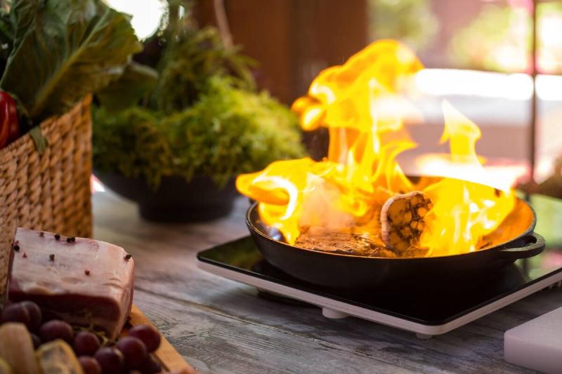 Food on fire in a pan. 