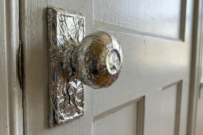 A doorknob wrapped in aluminum foil. 
