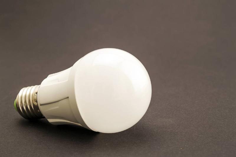 Glowing LED bulb on dark background.