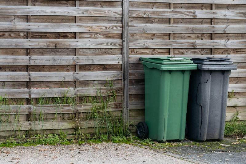 A simple privacy screen hiding garbage bins. 