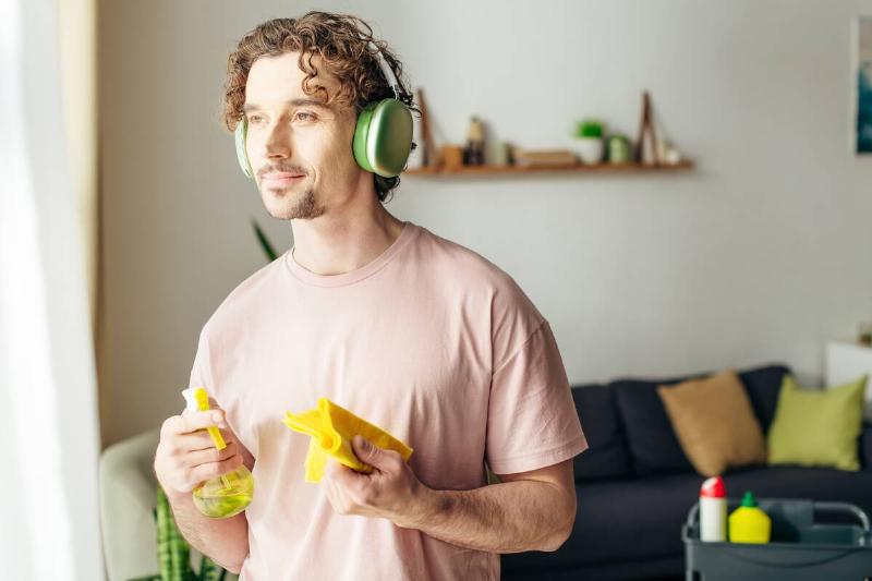 Man listening to podcast while cleaning. 