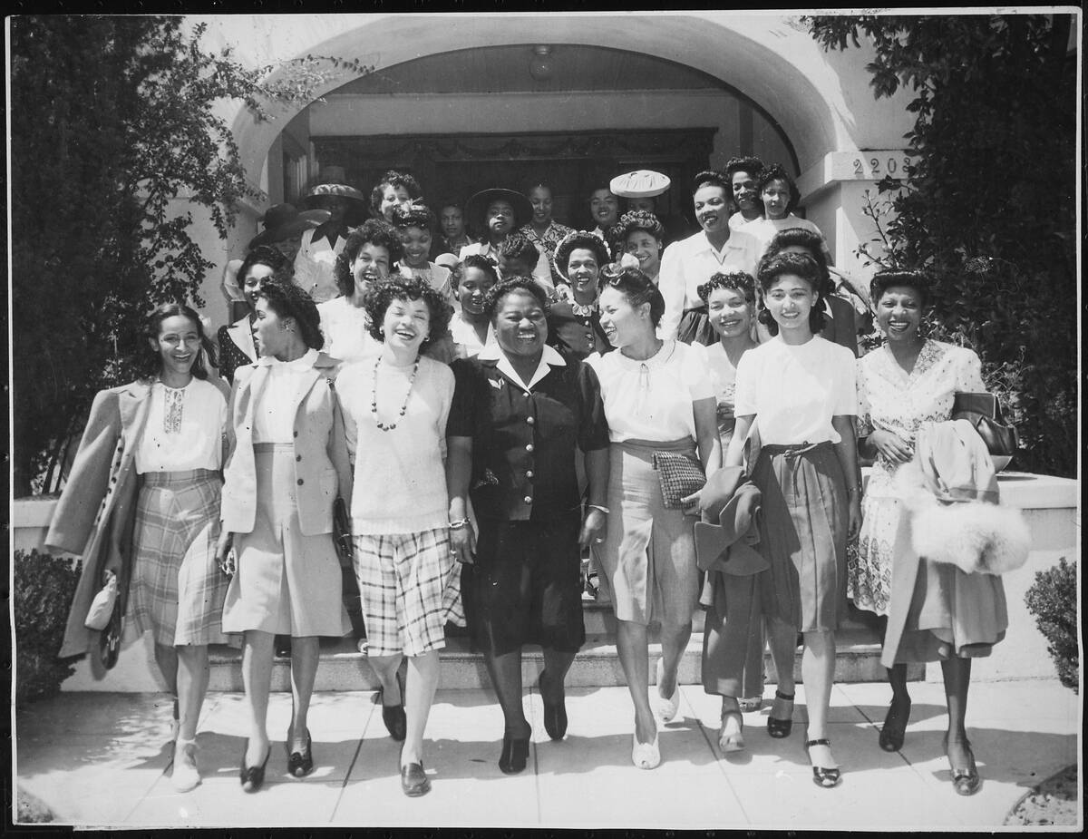 Hattie McDaniel walking with other members of the Hollywood Victory Committee