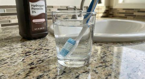 Hydrogen peroxide covering the bristles of a toothbrush. 