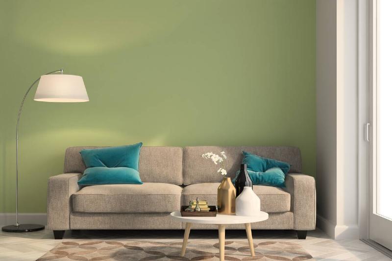 Room with green paint with brown undertones on wall. 